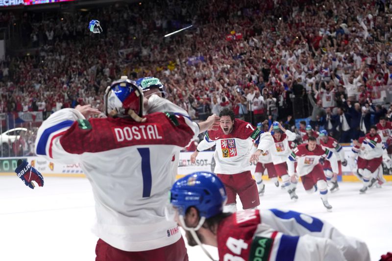Members of the Czech Republic team celebrates after they defeated Switzerland 2-0 in a gold medal match at the Ice Hockey World Championships in Prague, Czech Republic, Sunday, May 26, 2024. (AP Photo/Petr David Josek)