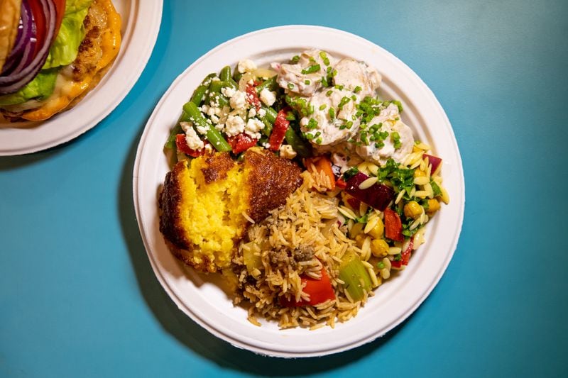 The sides at Nani’s Piri Piri Chicken include confit potato salad, green bean salad, savory corn pudding, dirty rice, and Mediterranean orzo salad. (Mia Yakel for The Atlanta Journal-Constitution)