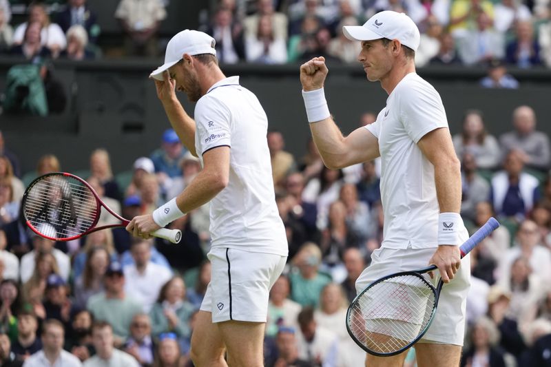 Andy, right, and Jamie Murray react during their first round doubles match against Australia's John Peers and Ricky Hijikata at the Wimbledon tennis championships in London, Thursday, July 4, 2024. (AP Photo/Kirsty Wigglesworth)