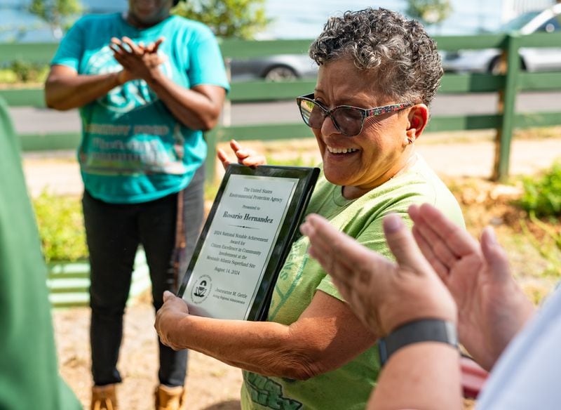 Historic Westside Gardens founder Rosario Hernandez reacts to receiving the EPA’s National Notable Achievement Award at a community garden run by Historic Westside Gardens in Atlanta on Wednesday, August 14, 2024. (Seeger Gray / AJC)