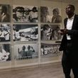 Dikembe Mutombo walks past photos from the Biamba Maria Mutombo Hospital in Kinshasa while leaving his office at the end of the work day on June 7, 2017, at the Dikembe Mutombo Foundation in Atlanta. (Curtis Compton/The Atlanta Journal-Constitution)