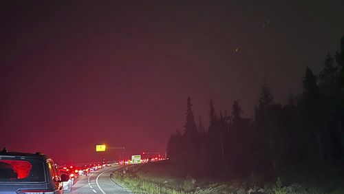 This photo provided by Carolyn Campbell shows cars clogging the highway as people evacuate because of wildfires early Tuesday, July 23, 2024, in Jasper, Alberta. Multiple wildfires in Canada’s Jasper National Park have flared up, forcing all park visitors along with the 4,700 residents of the Jasper townsite to flee. (Carolyn Campbell/The Canadian Press via AP)