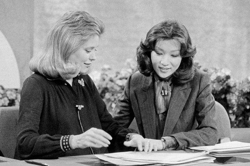 FILE - Connie Chung, right, works with Jane Pauley, Nov. 11, 1983, in New York, as she prepares to take over as hostess of NBC television's Today Show, as Pauley is taking maternity leave. (AP Photo/David Pickoff, File)