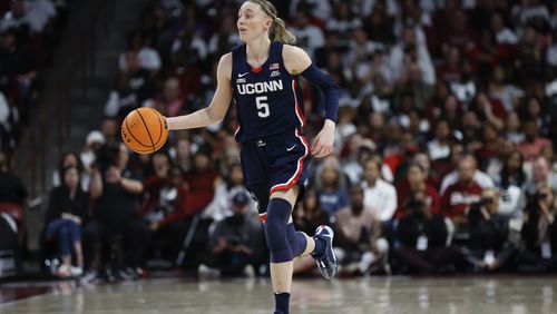 FILE - UConn guard Paige Bueckers brings the ball up court during the second half of an NCAA college basketball game against South Carolina in Columbia, S.C., Sunday, Feb. 11, 2024. (AP Photo/Nell Redmond, File)