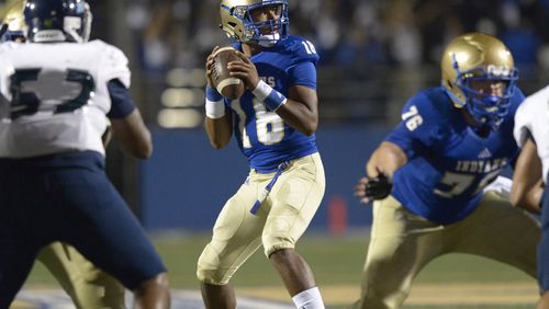 High School football: McEachern QB Carlos Del Rio (18) drops back to pass during the first half of Friday's home game against Cedar Grove. (Daniel Varnado/Special)