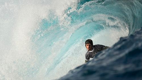 Joao Chianca, of Brazil, surfs on a training day ahead of the 2024 Summer Olympics surfing competition, Tuesday, July 23, 2024, in Teahupo'o, Tahiti. (AP Photo/Gregory Bull)