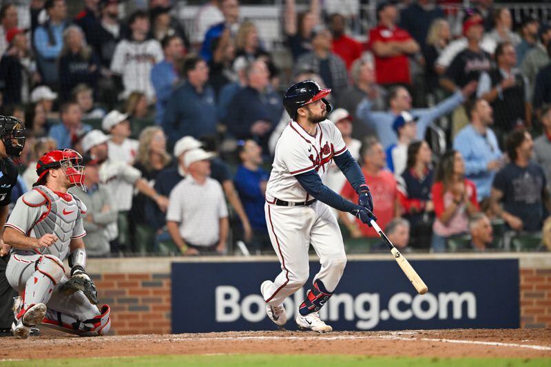 Atlanta Braves catcher Travis d'Arnaud (16) hits a two-run home run against the Philadelphia Phillies during the seventh inning of NLDS Game 2 in Atlanta on Monday, Oct. 9, 2023.   (Hyosub Shin / Hyosub.Shin@ajc.com)