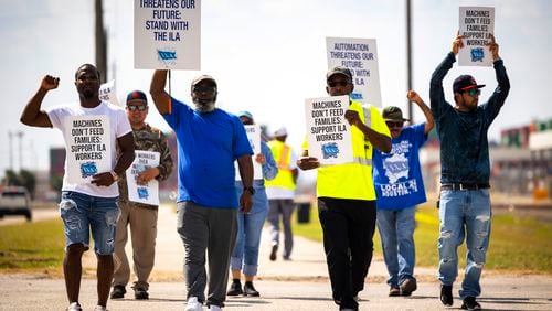 Longshoremen walk the picket line at the Barbours Cut Container Terminal during the first day of a dockworkers strike on Tuesday, Oct. 1, 2024, in Houston. (AP Photo/Annie Mulligan)