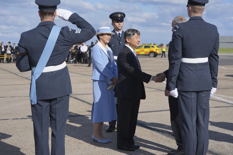 Emperor Naruhito and Empress Masako are greeted by dignitaries as they arrive at Stansted Airport, England, Saturday, June 22, 2024, ahead of a state visit. The state visit begins Tuesday, when King Charles III and Queen Camilla will formally welcome the Emperor and Empress before taking a ceremonial carriage ride to Buckingham Palace. (AP Photo/Kin Cheung)