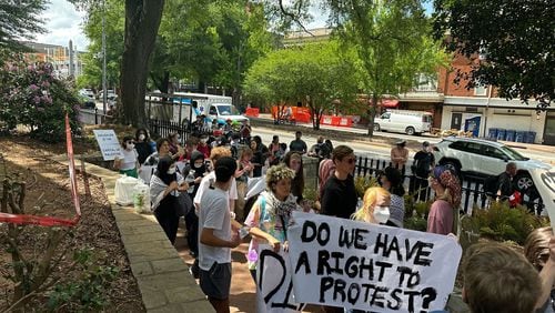 Demonstrators protesting the Israel-Hamas war in Gaza carry a banner asking "Do we have a right to protest?" at the University of Georgia on April 29. The University System of Georgia on July 1 published its annual free speech report, which stated that schools prepared extensively for campus protests. (Fletcher Page/AJC file photo)