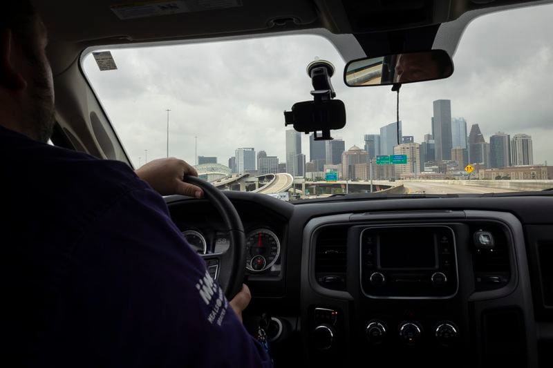 Meals on Wheels Director of Operations Matthew Wright drives back towards headquarters after delivering meals, Friday, July 12, 2024, in Houston. Meals on Wheels staff members bring not only a hot meal and a cold drink but also human connection to clients. (AP Photo/Annie Mulligan)