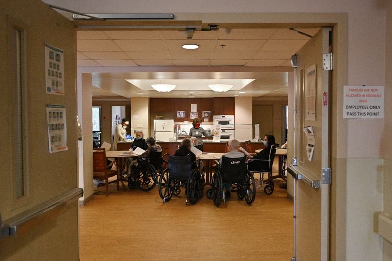 Karen Keeter, a volunteer, talks to senior residents during their morning gathering at William Breman Jewish Home in Atlanta on Wednesday, November 17, 2021. Harley Tabak, President and CEO of Jewish Home Life, which operates Breman, says, “We knew we had a lot of work to do and a lot of one-on-one discussions” to bring up the vaccination rates. “But we felt the safety of our residents and each other was our highest priority.” (Hyosub Shin / Hyosub.Shin@ajc.com)