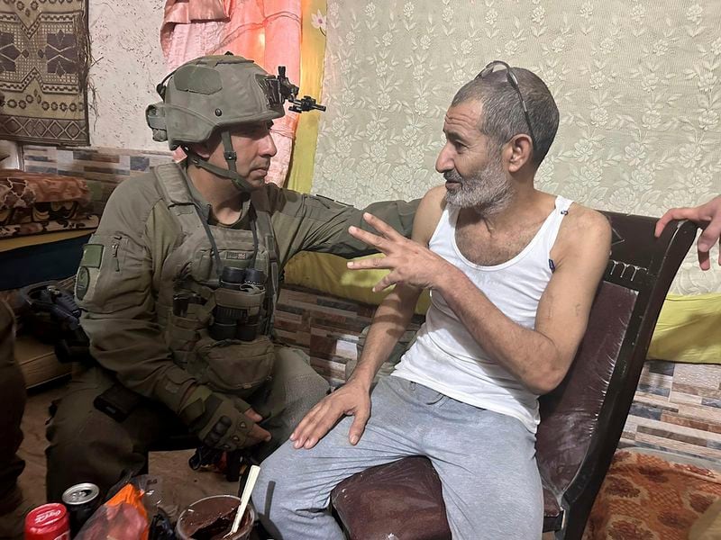 In this photo released by Israeli Defense Forces on Tuesday, Aug. 27, 2024, Qaid Farhan Alkadi, right, and the Commanding Officer of the 162nd Division, Brig. Gen. Itzik Cohen talk after a rescue operation. The military said on Tuesday that 52-year-old Qaid Farhan Alkadi was rescued "in a complex operation in the southern Gaza Strip." (Israeli Defense Forces via AP)