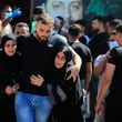 FILE - People react during the funeral procession of their relatives, who were killed in Monday's Israeli airstrikes, in the southern village of Saksakieh, Lebanon, Tuesday, Sept. 24, 2024. (AP Photo/Mohammed Zaatari, File)