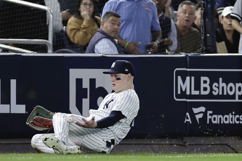 New York Yankees outfielder Alex Verdugo (24) comes up with the catch on a fly ball hit by Kansas City Royals' Michael Massey to end the fourth inning during Game 1 of the American League baseball division series, Saturday, Oct. 5, 2024, in New York. (AP Photo/Adam Hunger)