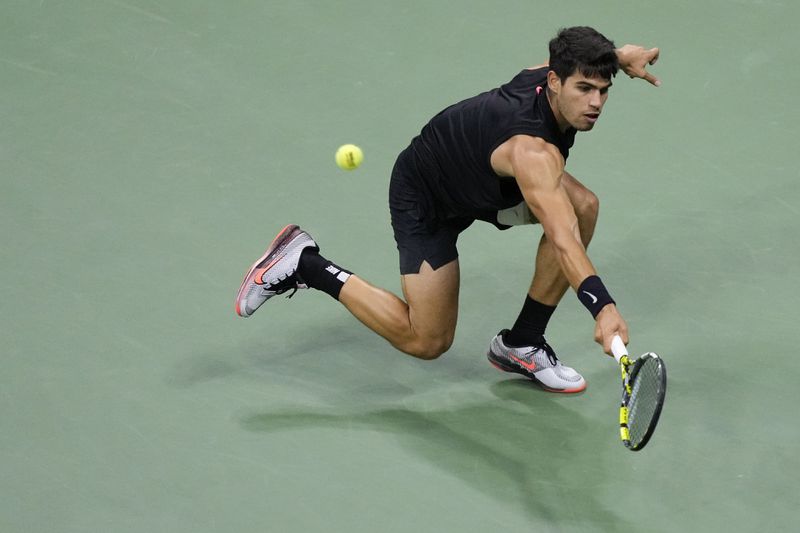 Carlos Alcaraz, of Spain returns a shot to Botic van De Zandschulp, of the Netherlands, during the second round of the U.S. Open tennis championships, Thursday, Aug. 29, 2024, in New York. (AP Photo/Matt Rourke)