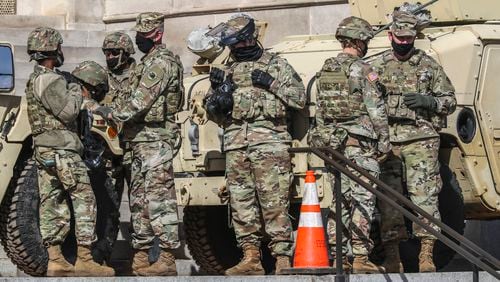 Members of the Georgia National Guard, the State Patrol and other law enforcement agencies surrounded the Georgia Capitol building on Jan. 20, 2021. (John Spink/The Atlanta Journal-Constitution)