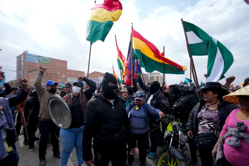 Supporters of Bolivia's President Luis Arce block supporters of former President Evo Morales from passing as they march to the capital to protest the Arce's government in El Alto, Bolivia, Sunday, Sept. 22, 2024. (AP Photo/Juan Karita)