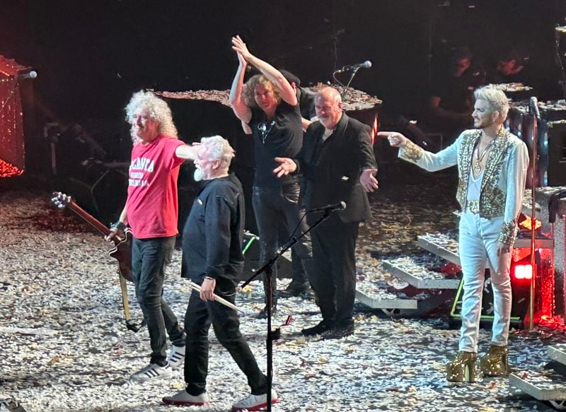 Original Queen members Brian May and Roger Taylor (left) ready to take a bow at the end of the State Farm Arena concert Oct. 23, 2023 while percussionist Tyer Warren, keyboardist Spike Edney and vocalist Adam Lambert look on. RODNEY HO@rho@ajc.com