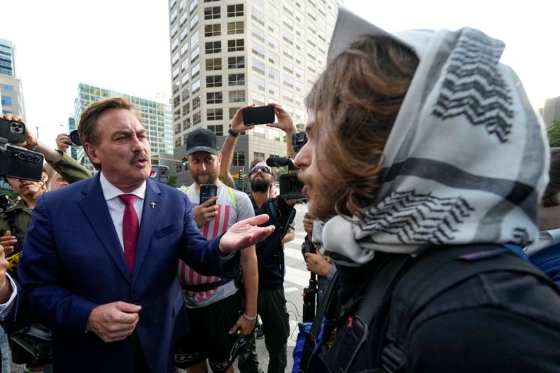 Election denier Mike Lindell of MyPillow and a demonstrator argue near the Israeli Consulate during the Democratic National Convention Tuesday, Aug. 20, 2024, in Chicago. (AP Photo/Julio Cortez)