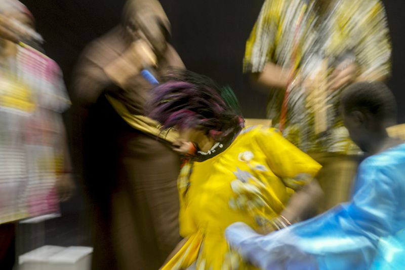 In this image taken with a slow shutter speed, Sudanese Camirata troupe dancers perform a "Al Hamal Rakd" dance from West Sudan, during a show at the Russian culture center in Cairo, Egypt, Sunday, Sept. 15, 2024. (AP Photo/Amr Nabil)