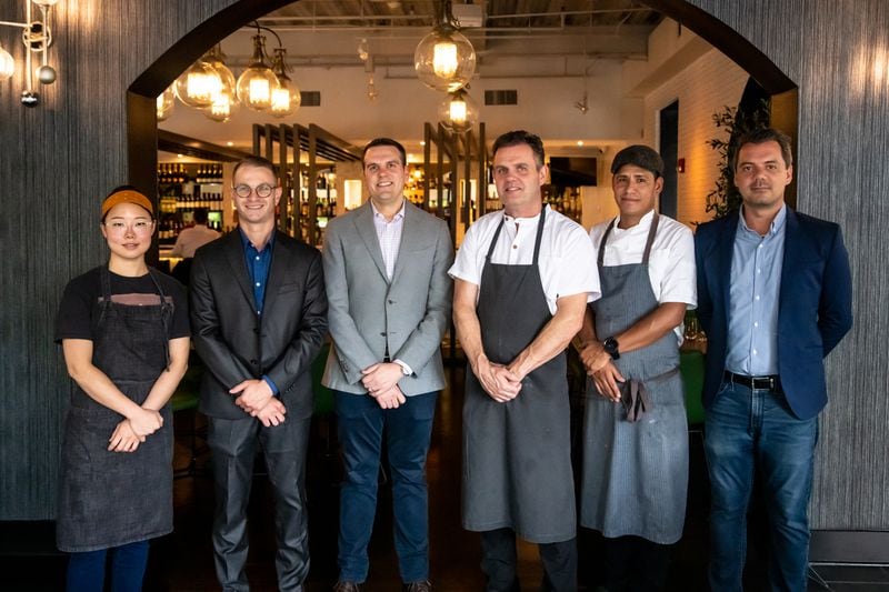 Tre Vele is the second restaurant from the team behind Mission + Market. From left to right are Jae Eun Park (pastry chef), Michael Davis (assistant general manager), Jonathan Akly (partner/co-owner), Ian Winslade (chef/partner), Giancarlo Ruiz (executive chef) and Gabriele Besozzi (general manager).  (Mia Yakel for The Atlanta Journal-Constitution)