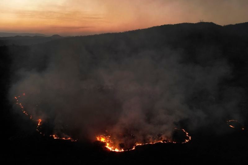 Fires spread through the environmental protection area of Pouso Alto, in Chapada dos Veadeiros National Park, during dry season, in Minas Sul, Goias state, Brazil, Monday, Sept. 9, 2024. (AP Photo/Eraldo Peres)