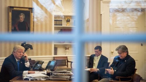 President Donald Trump speaks on the phone Saturday with Australian Prime Minister Malcolm Turnbull in the Oval Office – in the company of national security advisor Michael Flynn and White House chief strategist Steve Bannon. Drew Angerer/Getty Images