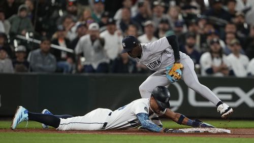 Seattle Mariners' Julio Rodríguez is picked off at third base by New York Yankees third baseman Jazz Chisholm Jr. after Mariners' Randy Arozarena lost his bat on a swing during the 10th inning of a baseball game Wednesday, Sept. 18, 2024, in Seattle. (AP Photo/Lindsey Wasson)