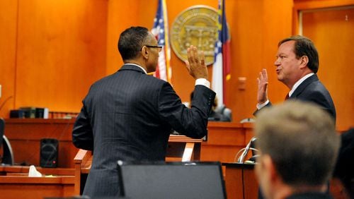 Suspended DeKalb County CEO Burrell Ellis is sworn in by defense attorney Craig Gillen before making a statement in his behalf before sentencing last year. Ellis was sentenced to 18 months in prison and 3½ years probation. KENT D. JOHNSON /KDJOHNSON@AJC.COM