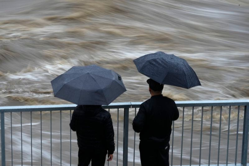 Residents watch the flow of the Bela River during floods in Mikulovice, Czech Republic, Saturday, Sept. 14, 2024. (AP Photo/Petr David Josek)