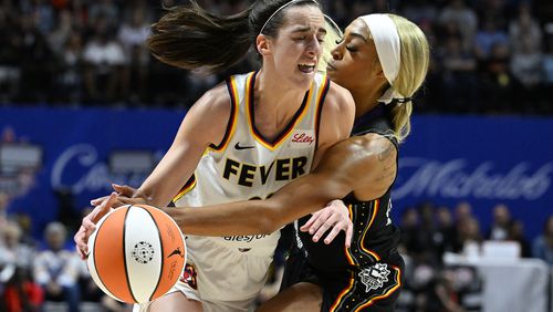 Connecticut Sun guard DiJonai Carrington (21) fouls Indiana Fever guard Caitlin Clark (22) during the third quarter of a WNBA basketball game, Tuesday, May 14, 2024, in Uncasville, Conn. (AP Photo/Jessica Hill)