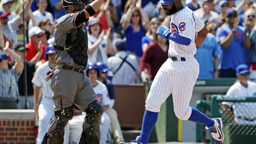 Chicago Cubs' Jason Heyward, right, scores on a double by Anthony Rizzo as Arizona Diamondbacks catcher Welington Castillo looks to the field during the sixth inning of a baseball game Friday, June 3, 2016, in Chicago. (AP Photo/Nam Y. Huh)