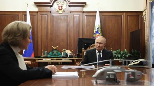 Russian President Vladimir Putin, right, speaks with Anna Popova, the Head of the Federal Service for the Oversight of Consumer Protection and Welfare, during their meeting at the Kremlin in Moscow, Russia, Monday, Sept. 16, 2024. (Alexander Kazakov, Sputnik, Kremlin Pool Photo via AP)