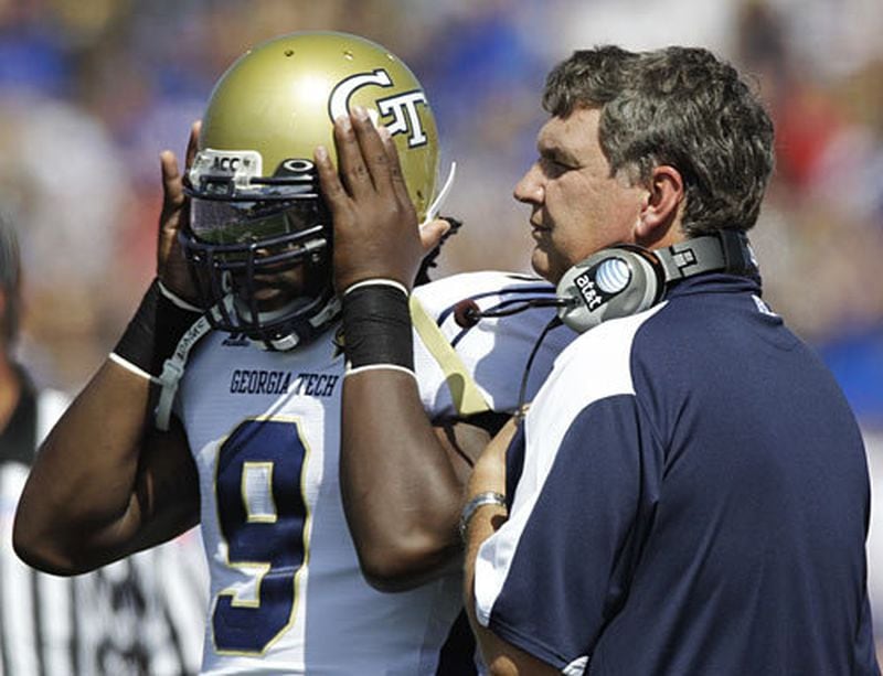 Yellow Jackets quarterback Joshua Nesbitt (9) and coach Paul Johnson talk on the sideline during the first half.