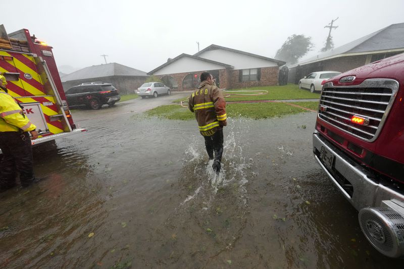 Morgan City firefighters respond to a home fire during Hurricane Francine in Morgan City, La., Wednesday, Sept. 11, 2024. (AP Photo/Gerald Herbert)