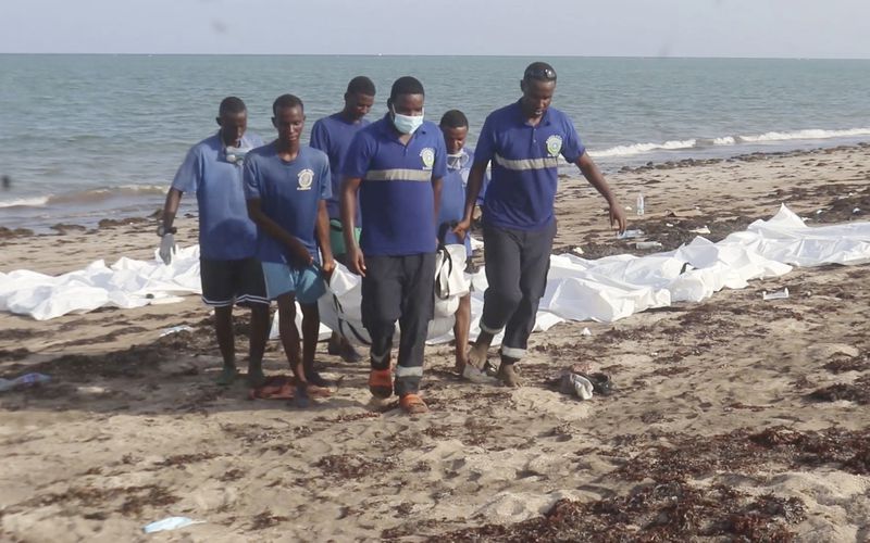 In this image made from video, Djiboutian coast guard workers load bodies of migrants who were washed away on the shore of the Red Sea, off the coast in Djibouti Wednesday, Oct. 2, 2024. The U.N. migration agency says two vessels carrying migrants from Africa sank in the Red Sea killing 45 people. (Djiboutian Coast Guard via AP)