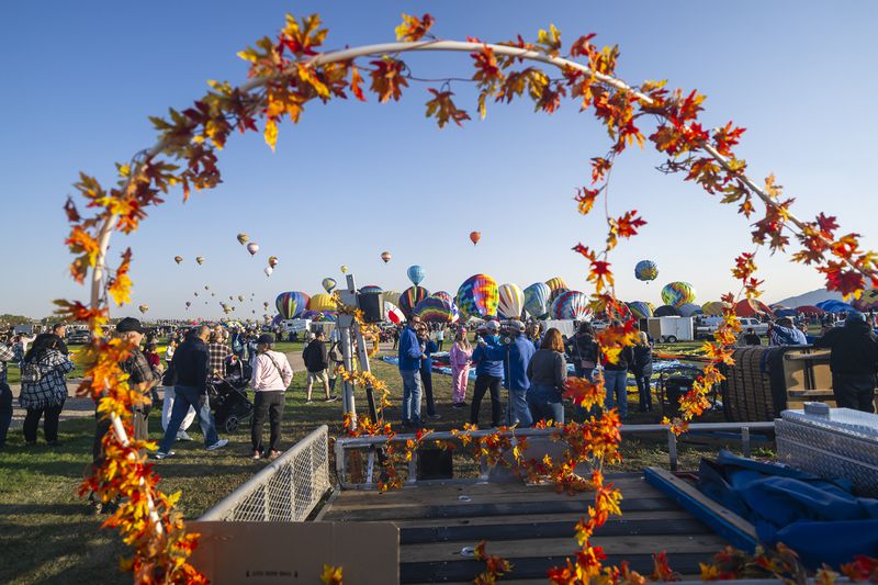 Spectators watch as hot air balloons take off during the mass ascension at the 52nd Albuquerque International Balloon Fiesta in Albuquerque, N.M., on Saturday, Oct. 5, 2024. (AP Photo/Roberto E. Rosales)