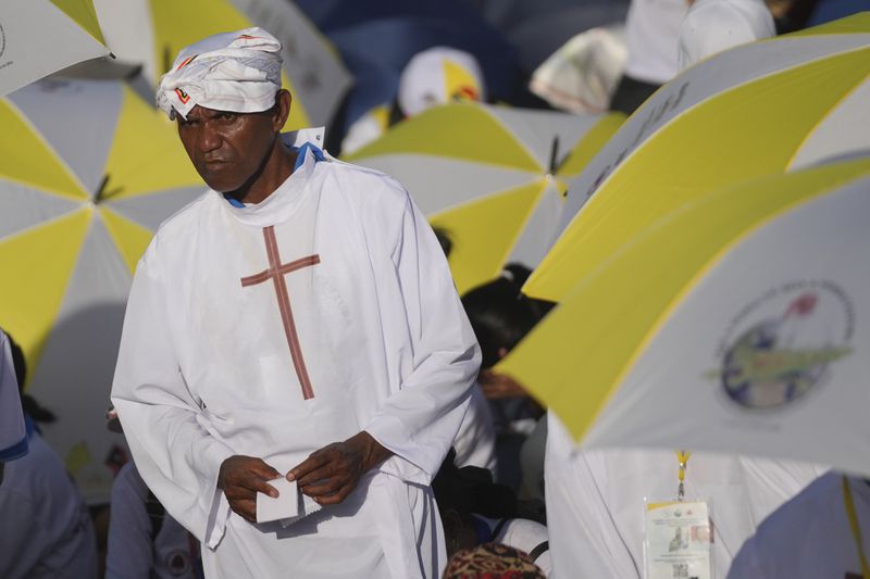 A faithful attends the holy mass lead by Pope Francis at Tasitolu park in Dili, East Timor, Tuesday, Sept. 10, 2024. (AP Photo/Dita Alangkara, Pool)