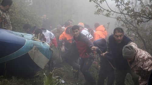 FILE - In this photo provided by Moj News Agency, rescue team members work at the scene of a crash of a helicopter carrying Iranian President Ebrahim Raisi in Varzaghan in northwestern Iran, Monday, May 20, 2024. (Azin Haghighi, Moj News Agency via AP, File)