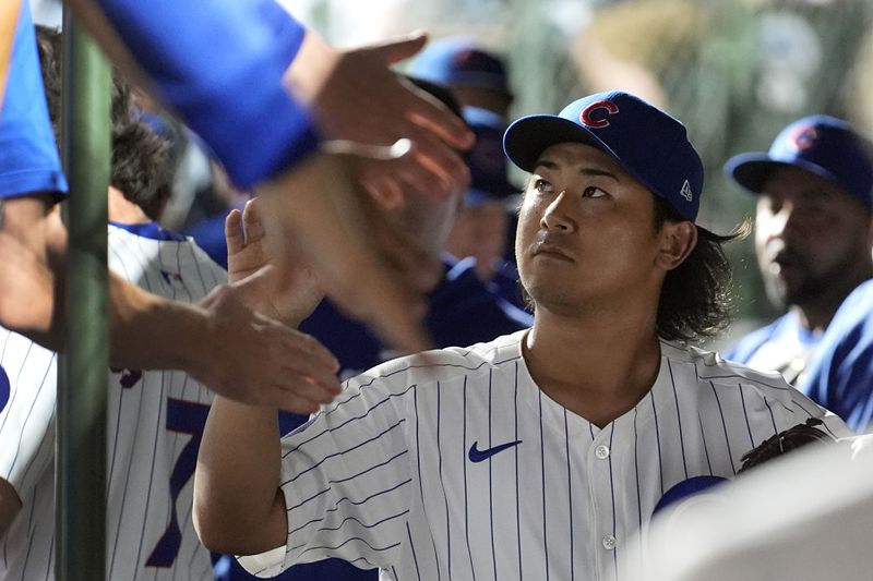 Chicago Cubs pitcher Shota Imanaga is greeted in the dugout after pitching seven innings of no-hit ball in a baseball game against the Pittsburgh Pirates, Wednesday, Sept. 4, 2024, in Chicago. (AP Photo/Charles Rex Arbogast)