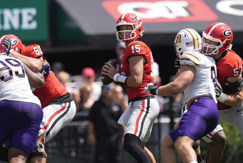 Georgia quarterback Carson Beck (15) looks for an open reciever during the first half of an NCAA college football game against Tennessee Tech Saturday, Sept. 7, 2024, in Athens, ga. (AP Photo/John Bazemore)