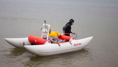 Jim Dreyer heads out into Lake Michigan in Grant Haven, Mich., Aug. 6, 2024, in his attempt to swim to Wisconsin. (Blace Carpenter/The Tribune via AP)