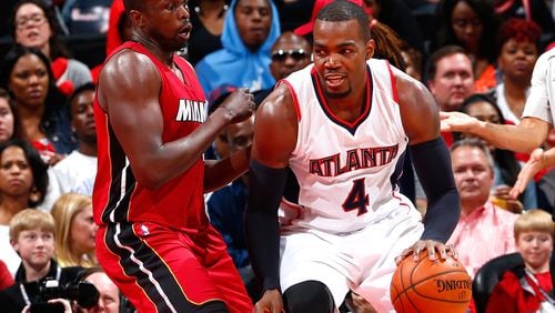 ATLANTA, GA - MARCH 27: Paul Millsap #4 of the Atlanta Hawks drives against Luol Deng #9 of the Miami Heat at Philips Arena on March 27, 2015 in Atlanta, Georgia. NOTE TO USER: User expressly acknowledges and agrees that, by downloading and/or using this photograph, user is consenting to the terms and conditions of the Getty Images License Agreement. (Photo by Kevin C. Cox/Getty Images) Paul Millsap, who had 21 points and nine rebounds against Miami, has been Hawks' best player. (Kevin C. Cox, Getty Images)