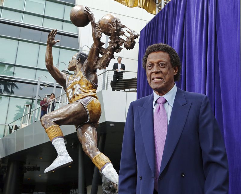 Elgin Baylor stands next to a statue, just unveiled, honoring the Minneapolis and Los Angeles Lakers great, outside Staples Center in Los Angeles on Friday, April 6, 2018. (Reed Saxon/AP)