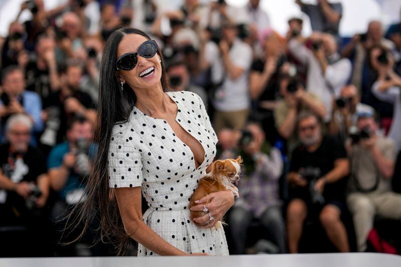 Demi Moore poses with her dog Pilaf for photographers at the photo call for the film 'The Substance' at the 77th international film festival, Cannes, southern France, Monday, May 20, 2024. (Photo by Andreea Alexandru/Invision/AP)