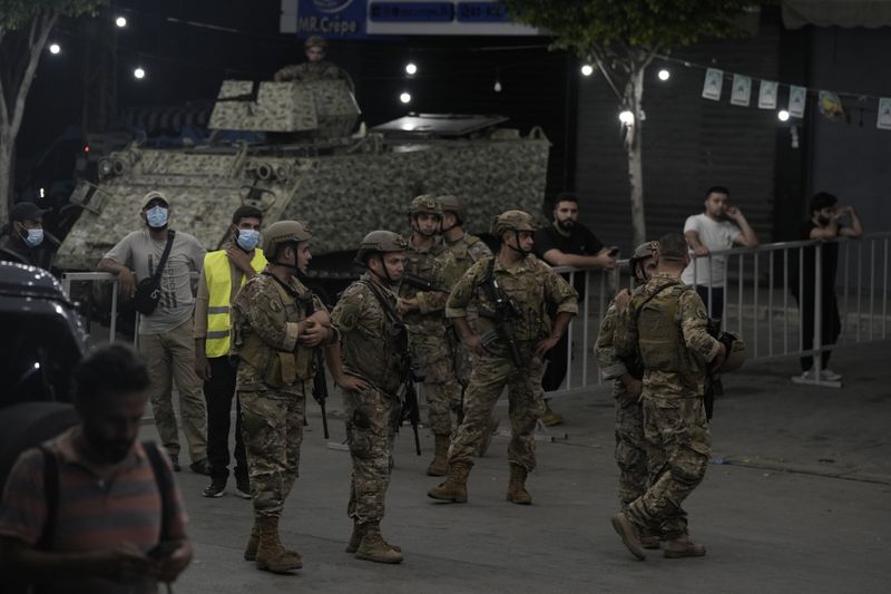 Lebanese soldiers secure the area near the site of an Israeli airstrike in Beirut's southern suburb, Monday, Sept. 23, 2024. (AP Photo/Bilal Hussein)