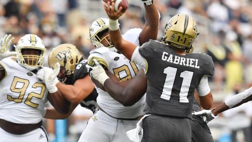 September 19, 2020 Atlanta - University of Central Florida's quarterback Dillon Gabriel (11) gets off a pass under pressure from Georgia Tech's defensive lineman Mike Lockhart (94) during the second half of an NCAA college football game at Georgia Tech's Bobby Dodd Stadium in Atlanta on Saturday, September 19, 2020. UCF won 49-21 over the Georgia Tech. (Hyosub Shin / Hyosub.Shin@ajc.com)