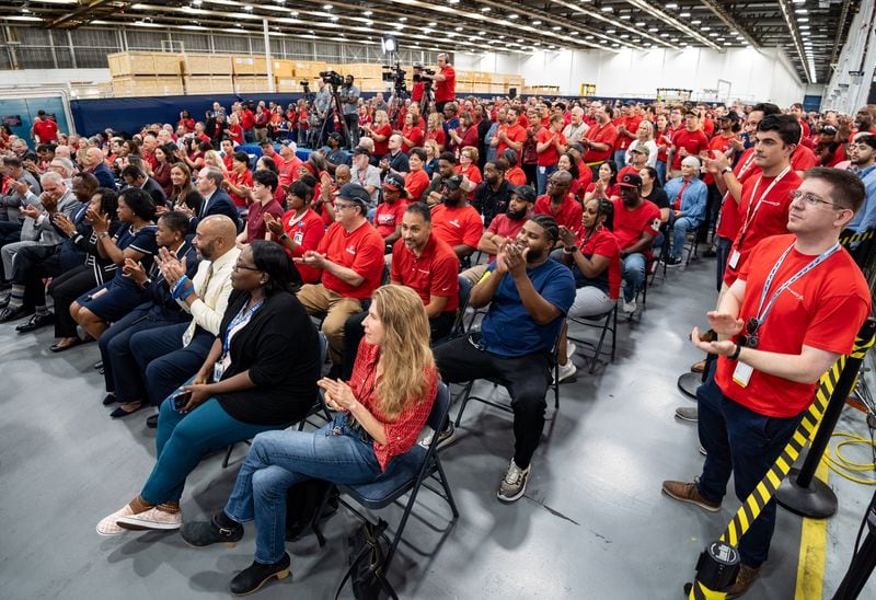 Employees clap during a presentation about the C-130J cargo aircraft at Lockheed Martin's manufacturing facility in Marietta on Thursday, Aug. 22. (Seeger Gray/AJC)