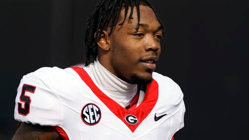 FILE - Georgia wide receiver Rara Thomas (5) warms up before an NCAA college football game against Vanderbilt, Saturday, Oct. 14, 2023, in Nashville, Tenn. Thomas was arrested on charges of cruelty to children and battery early Friday, July 26, 2024, in Athens, Ga., adding to the team's recent legal woes. (AP Photo/George Walker IV, File)